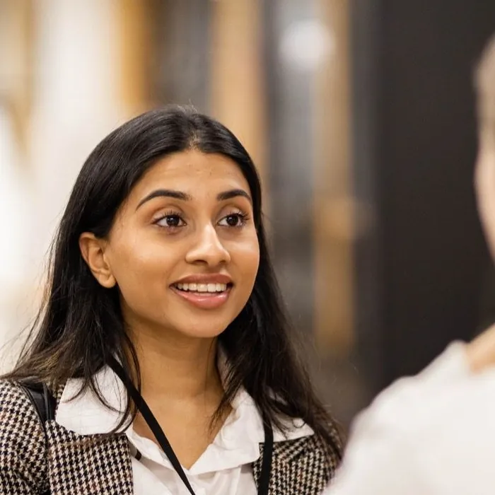 Bhavisha Valgi, smiling as she listens.